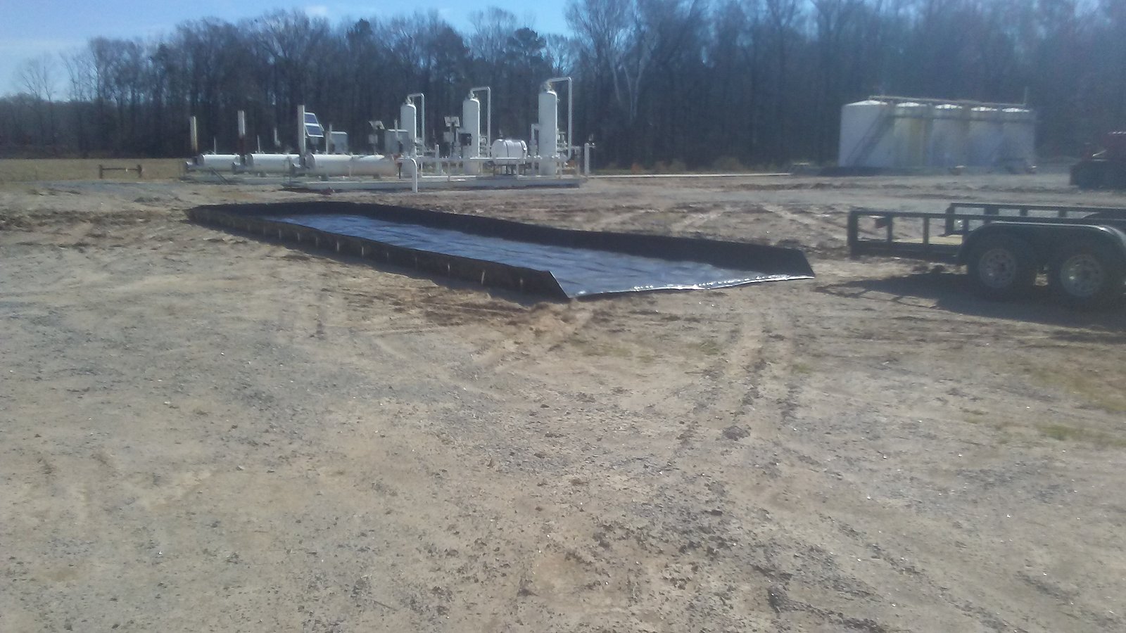 Black containment berm on a location